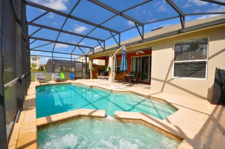 private swimming pool with spa in foreground and patio and villa in background